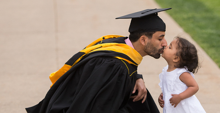 University of Iowa Graduate kissing child