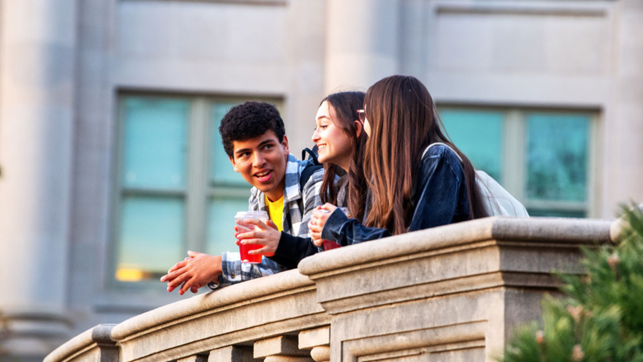 Students talking on porch at the old capital building